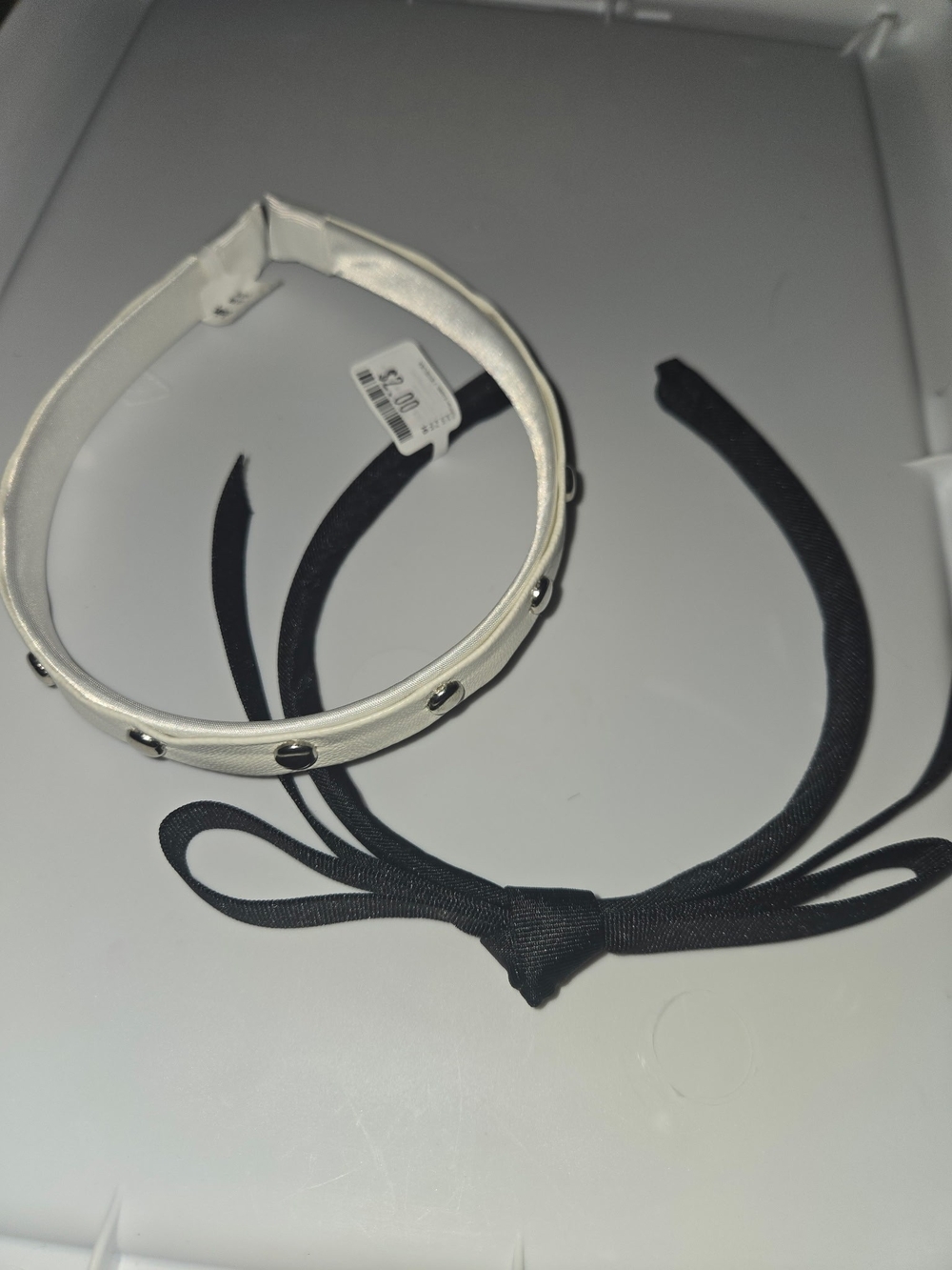 Studded White Leatherette Headband with Black Bow Accent